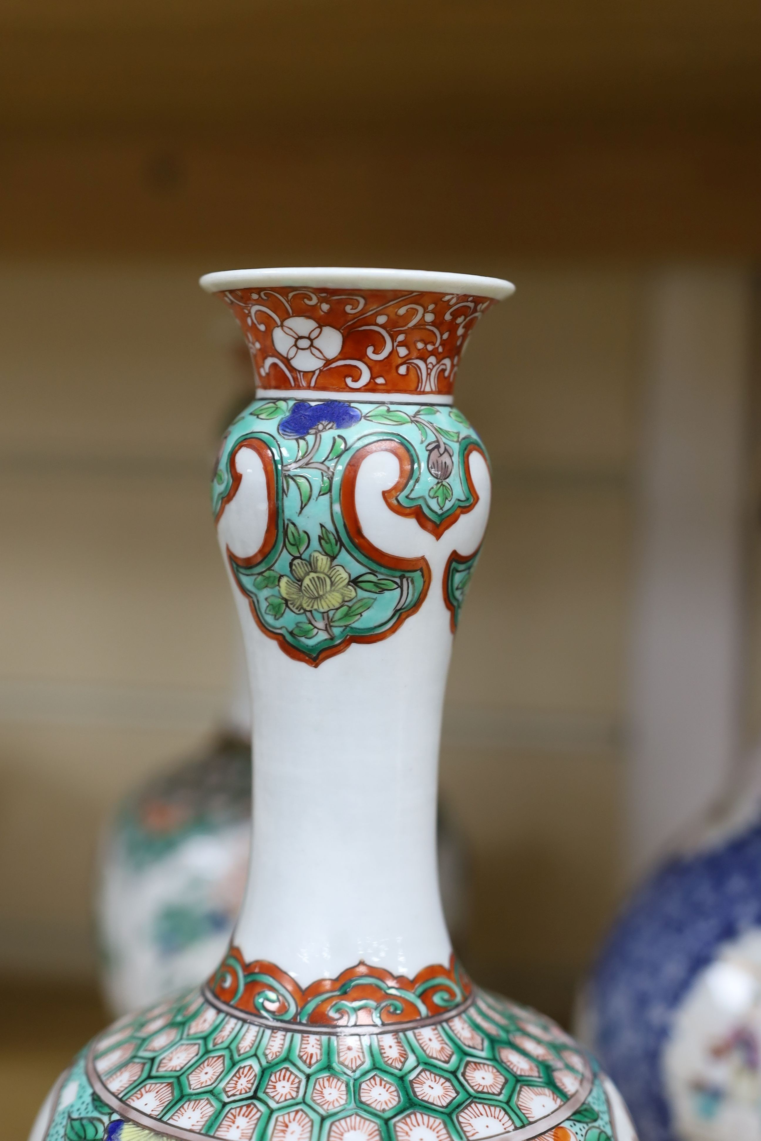 A pair Samson of Paris vases in the Chinese famille verte style and a Chinese Qianlong famille rose garlic neck vase with blue panelling motif, tallest 26cm